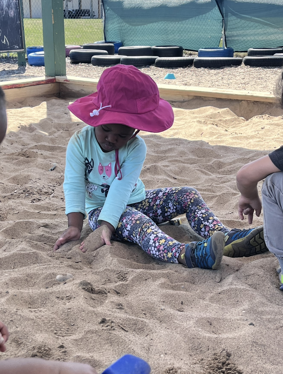 child playing in a sandbox
